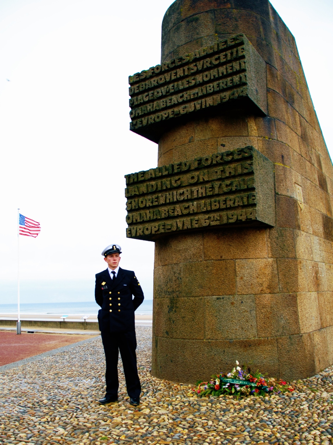 Emil at the D-Day monument on Omaha Beach, Normandy, in Norwegian Navy dress uniform with the American flag, 2008